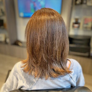 Women's short haircut with warm brown color