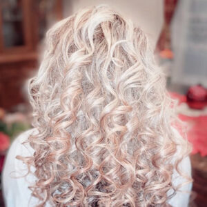Curly hair long cut with light pink added color