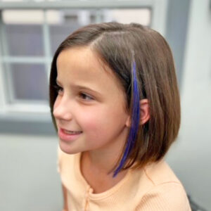 Girls cut with complementary color hair clip
