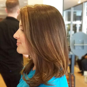 Woman's medium length haircut, with warming color, and style